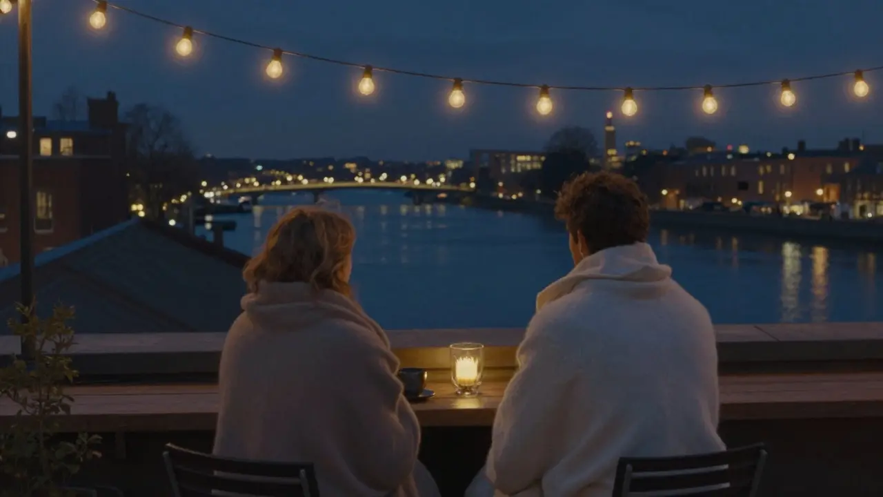 Romantic rooftop terrace at night with couple wrapped in blankets overlooking the Thames.